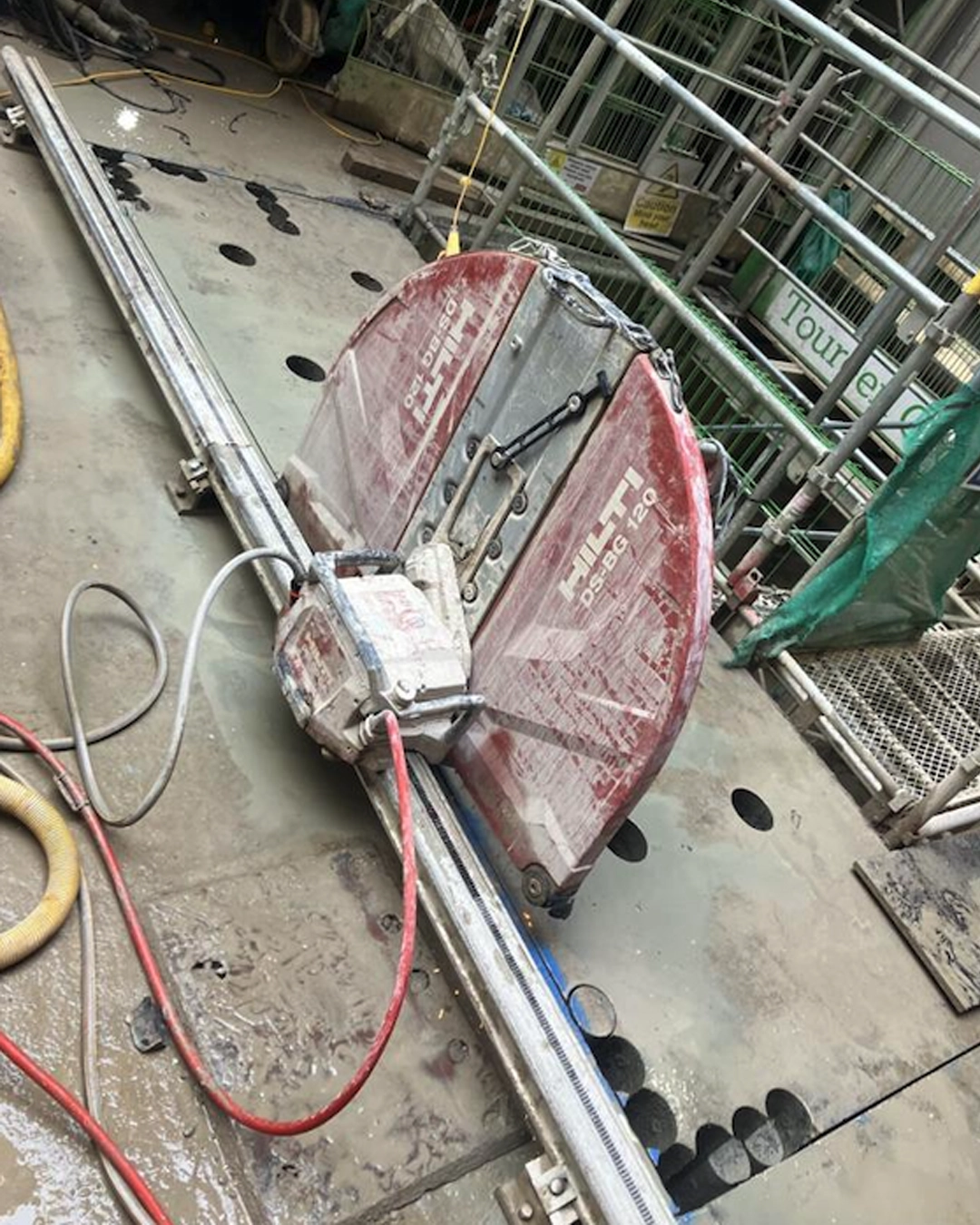 Track-mounted diamond wall saw cutting an opening in a concrete wall in Bristol