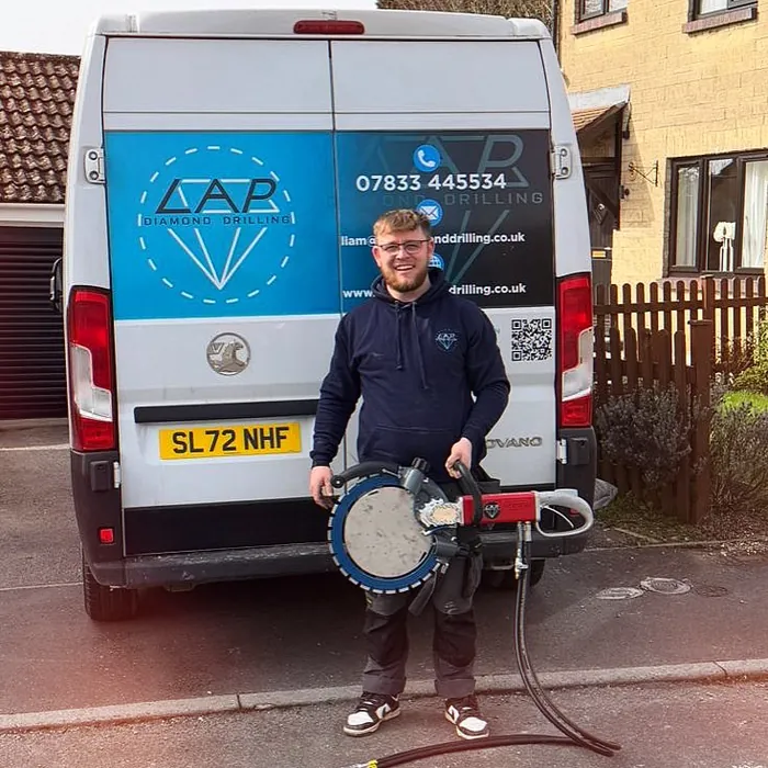 Liam Palmer with a hydraulic ring saw in front of the LAP Diamond Drilling van